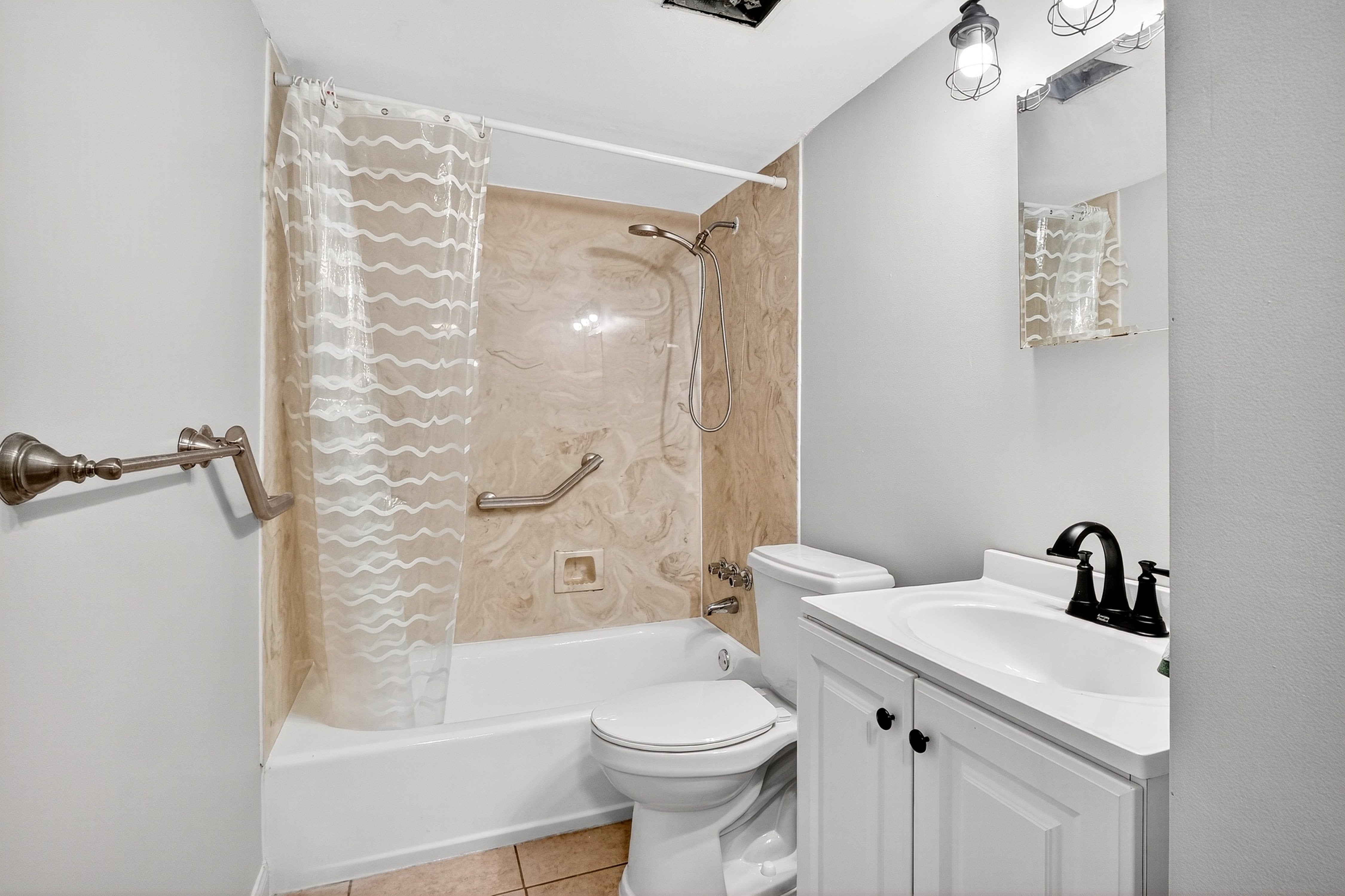 Bathroom with shower, bathtub, toilet, and sink.