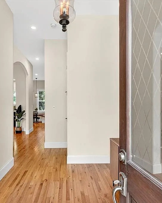 Modern interior with wooden floors, white walls, and decorative elements.