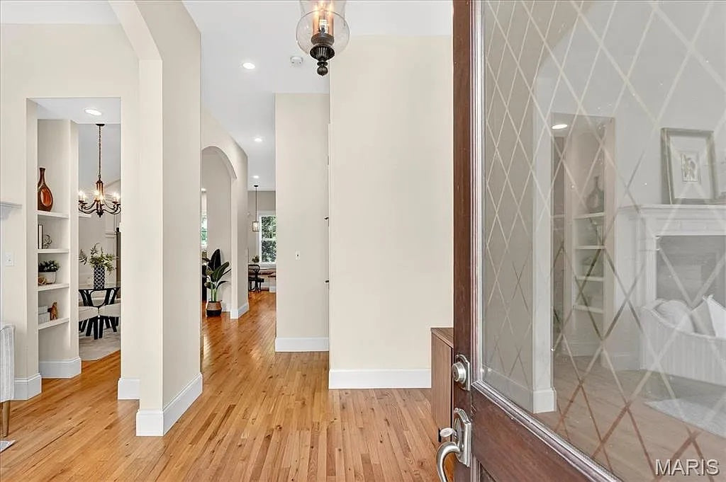 Modern interior with wooden floors, white walls, and decorative elements.