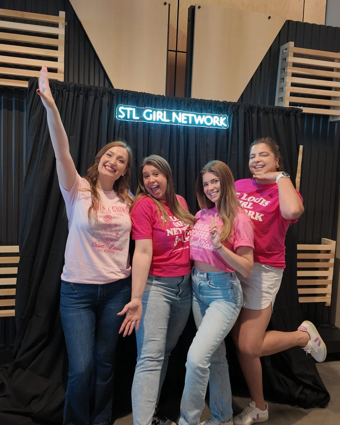 Women posing in front of a black background that says STL Girl Network