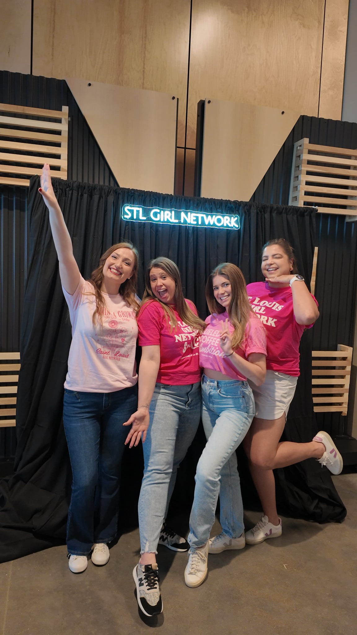 Women posing in front of a black background that says STL Girl Network
