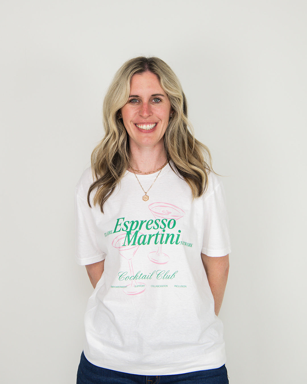 Woman wearing a white t-shirt with 'Espresso Martini' text on a plain background