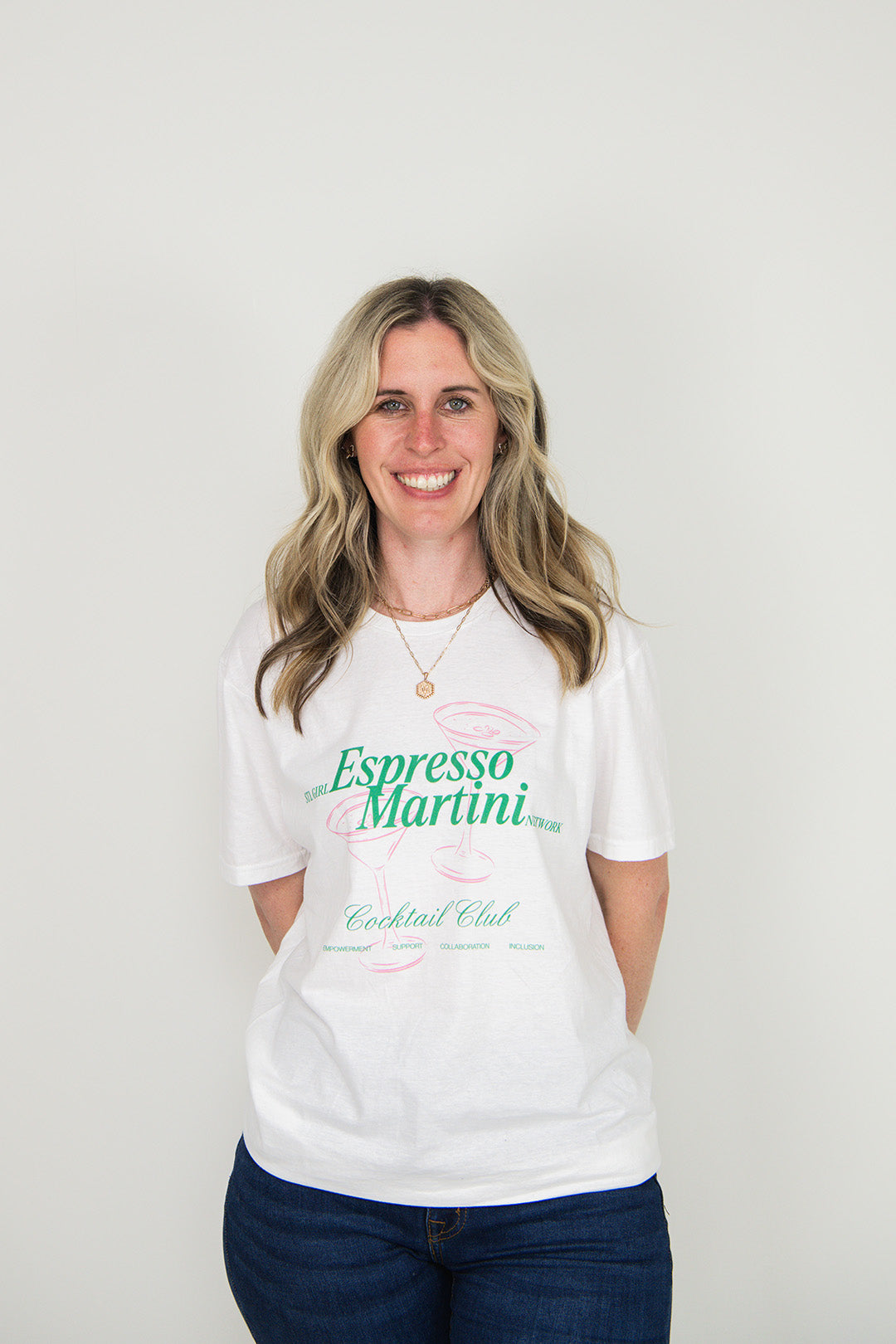 Woman wearing a white t-shirt with 'Espresso Martini' text on a plain background