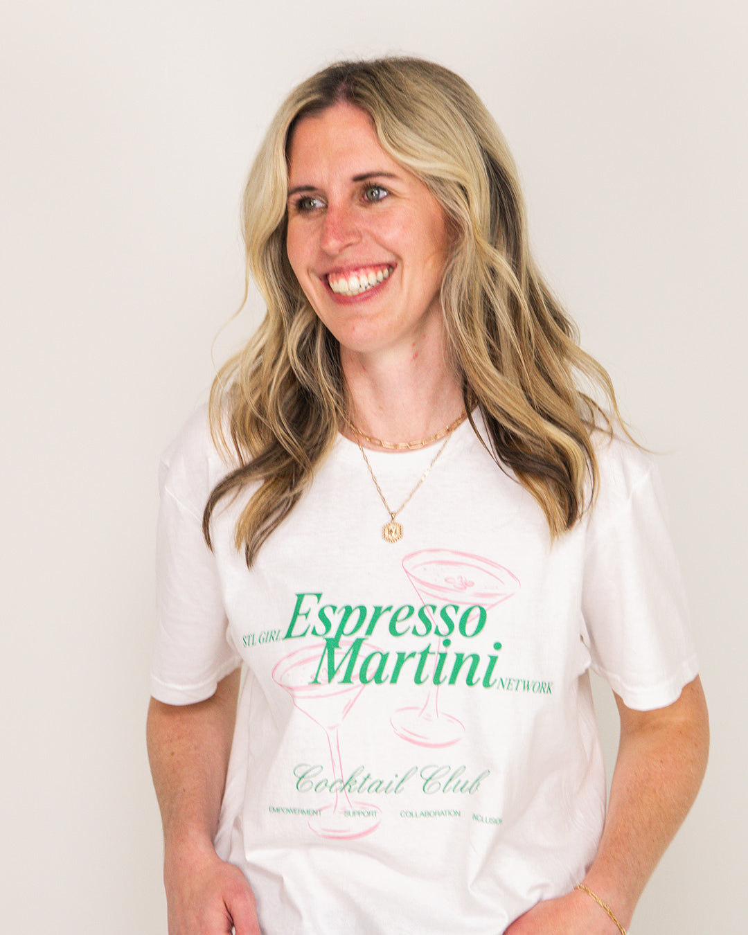 Woman wearing a white t-shirt with 'Espresso Martini' text on a plain background