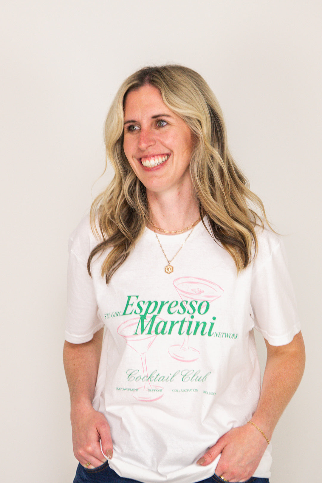 Woman wearing a white t-shirt with 'Espresso Martini' text on a plain background