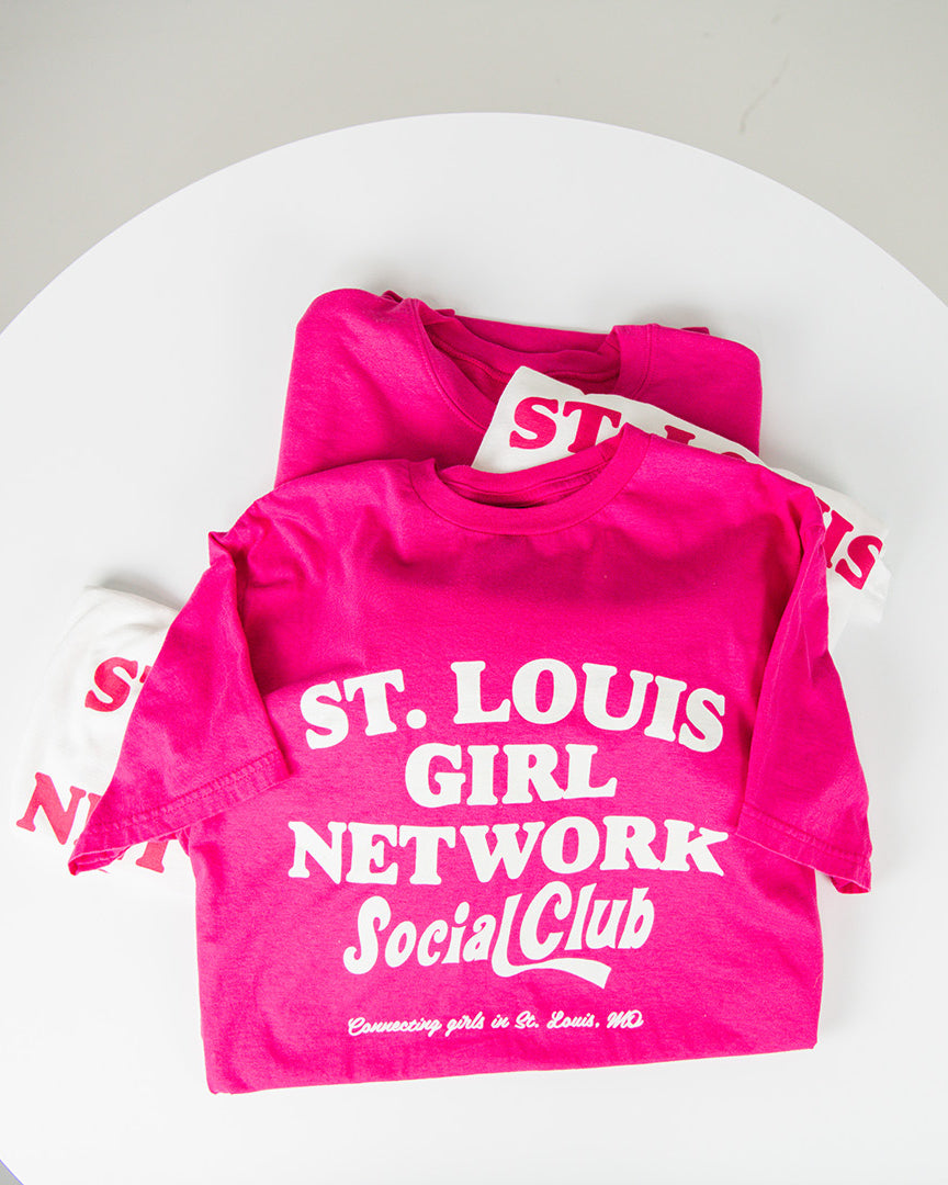 Pink t-shirt with 'St. Louis Girl Network Social Club' text on a white background