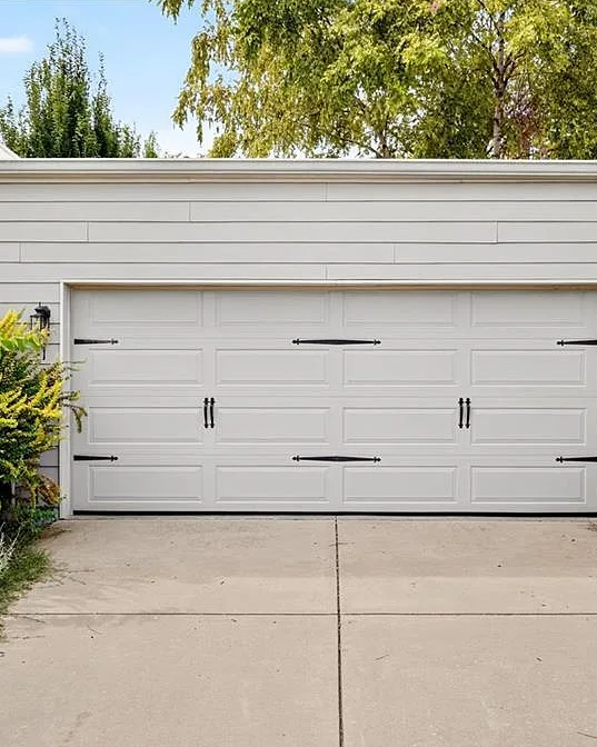 Modern garage door with decorative elements on a sunny day