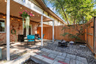 Backyard patio area with outdoor furniture and plants